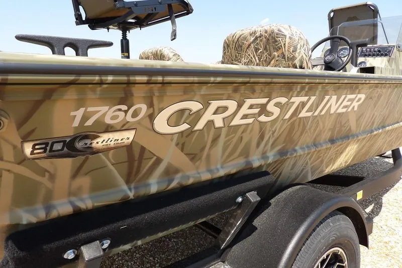Slide: The Image of 2026 Crestliner 1760 Retriever SC boat with camouflage design on trailer. - 36