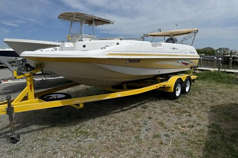 The Image of 2011 Hurricane SunDeck Sport 201 OB boat on yellow trailer, parked outdoors. - 0