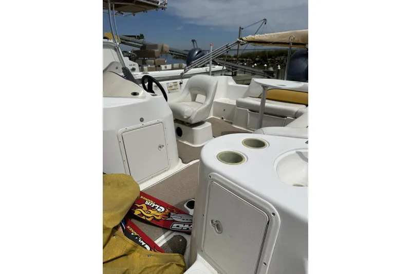Slide: The Image of 2011 Hurricane SunDeck Sport 201 OB boat interior with seating and storage compartments. - 2
