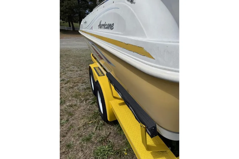 Slide: The Image of 2011 Hurricane SunDeck Sport 201 OB boat on yellow trailer, side view. - 4