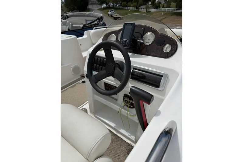 Slide: The Image of 2011 Hurricane SunDeck Sport 201 OB boat dashboard with steering wheel and controls. - 5
