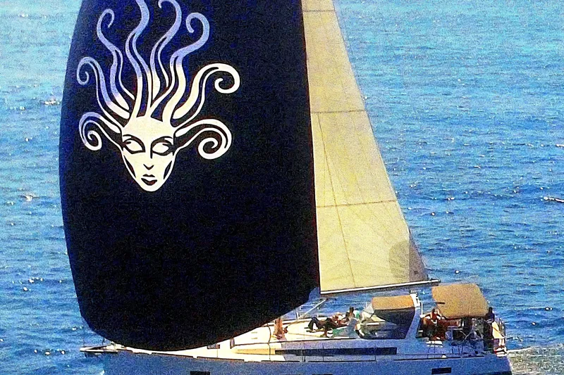 The Image of Beneteau Oceanis 55 sailboat with artistic sail design, cruising on blue ocean waters. - 0