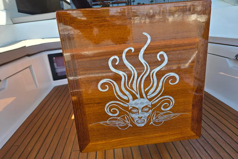 Slide: The Image of Wooden panel with intricate design on a 2016 Beneteau Oceanis 55 yacht deck. - 10