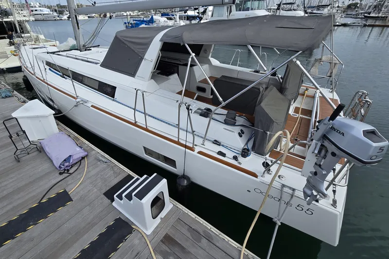 Slide: The Image of 2016 Beneteau Oceanis 55 yacht docked at marina, featuring sleek design and spacious deck. - 14