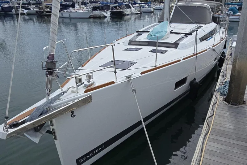 Slide: The Image of 2016 Beneteau Oceanis 55 yacht docked in a marina, showcasing sleek design and modern features. - 15