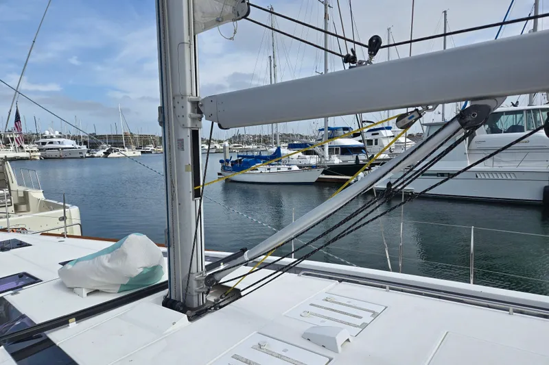 Slide: The Image of Beneteau Oceanis 55 sailboat docked in marina, 2016 model, with visible rigging and mast. - 17