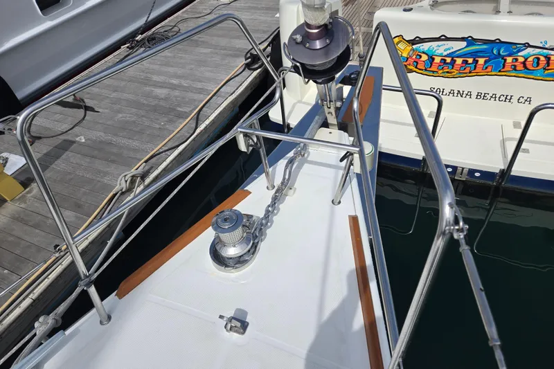 Slide: The Image of Beneteau Oceanis 55 (2016) yacht bow with anchor chain and winch at dock. - 20