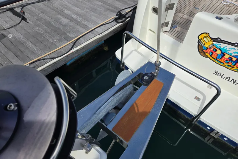 Slide: The Image of Beneteau Oceanis 55 yacht docked, showcasing deck details and vibrant graphics. - 21