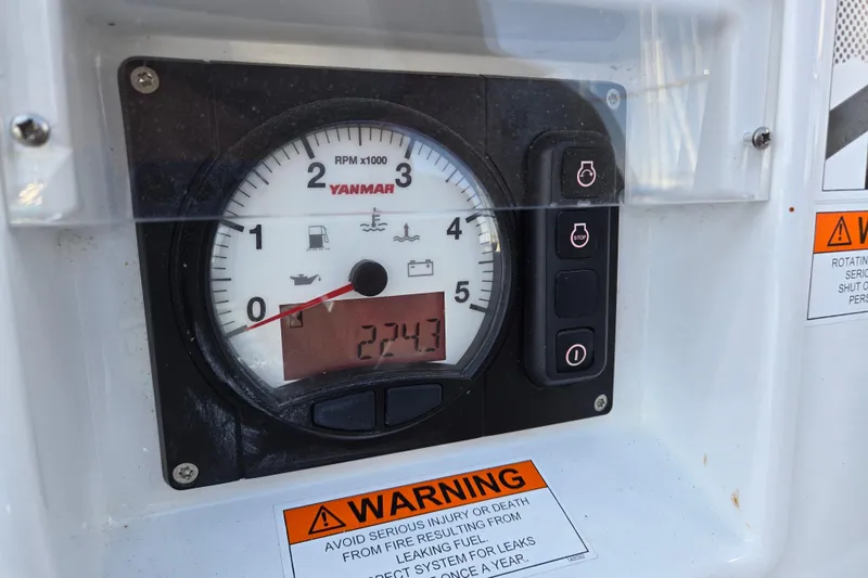 Slide: The Image of Yanmar engine control panel on a 2016 Beneteau Oceanis 55 sailboat, displaying RPM and warning labels. - 25