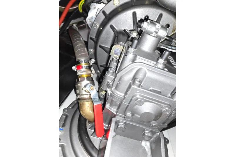Slide: The Image of Engine components of a 2016 Beneteau Oceanis 55 sailboat, featuring hoses and metal fittings. - 27