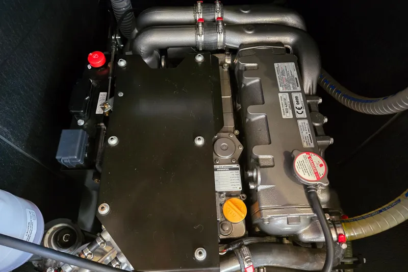 Slide: The Image of Engine compartment of a 2016 Beneteau Oceanis 55 sailboat, showcasing mechanical components. - 28