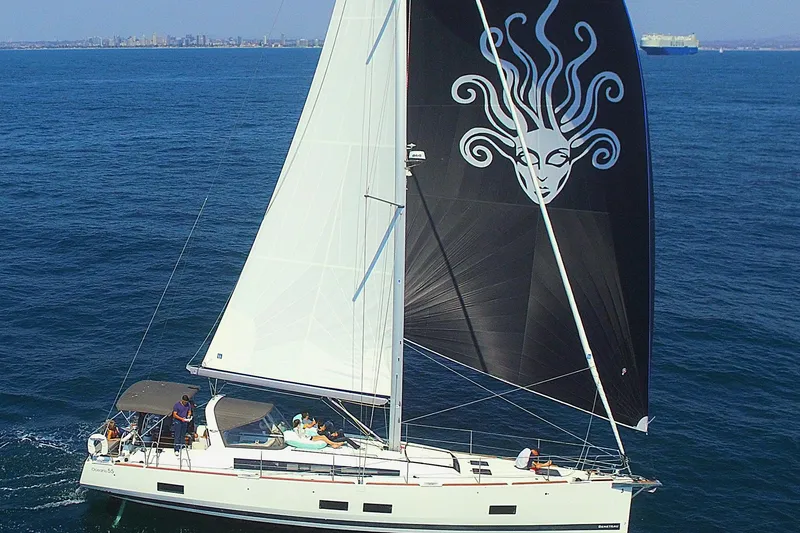 Slide: The Image of 2016 Beneteau Oceanis 55 sailing yacht with distinctive black sail design on open sea. - 3