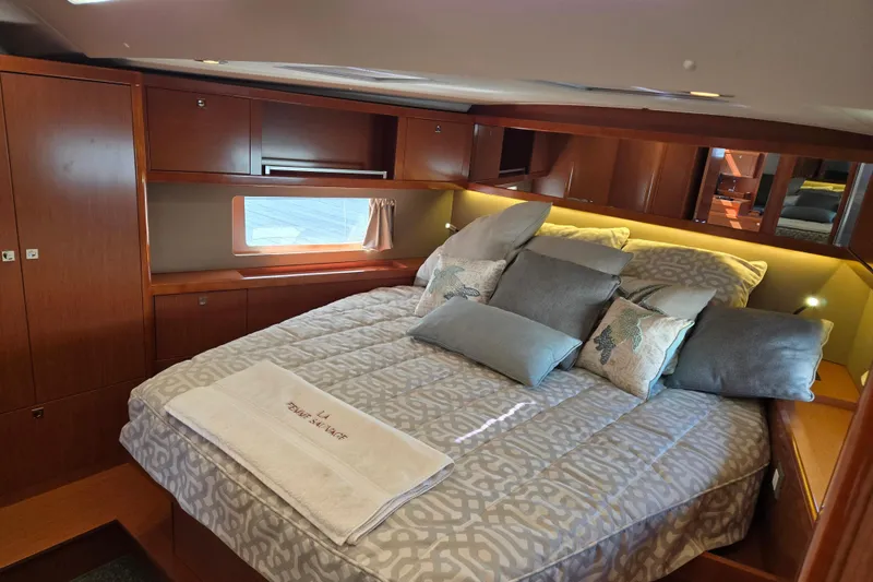 Slide: The Image of Luxurious cabin interior of a 2016 Beneteau Oceanis 55 yacht with elegant bedding. - 31
