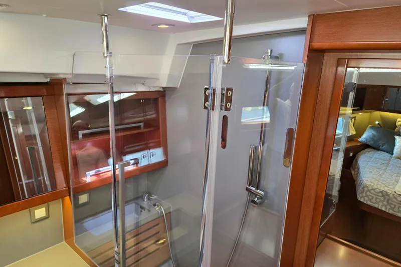 Slide: The Image of Interior of 2016 Beneteau Oceanis 55 yacht featuring modern shower and cozy bedroom. - 34