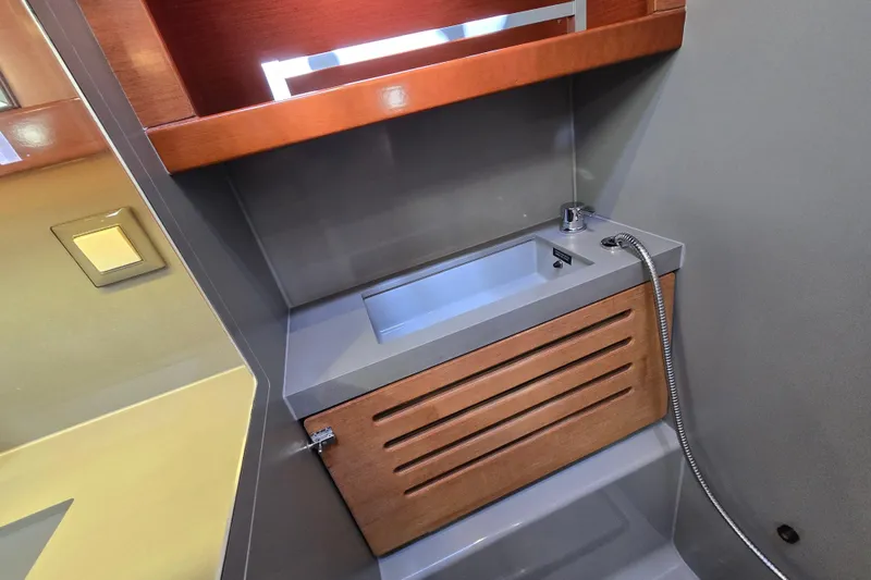 Slide: The Image of Modern bathroom sink in 2016 Beneteau Oceanis 55 yacht, featuring sleek design and wood accents. - 36
