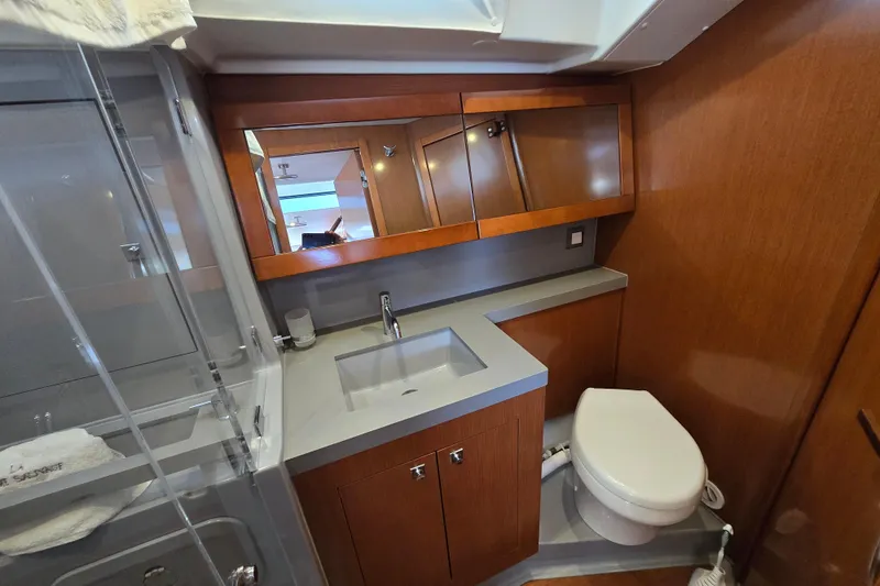 Slide: The Image of Luxurious bathroom in 2016 Beneteau Oceanis 55 yacht with modern fixtures and wood accents. - 39