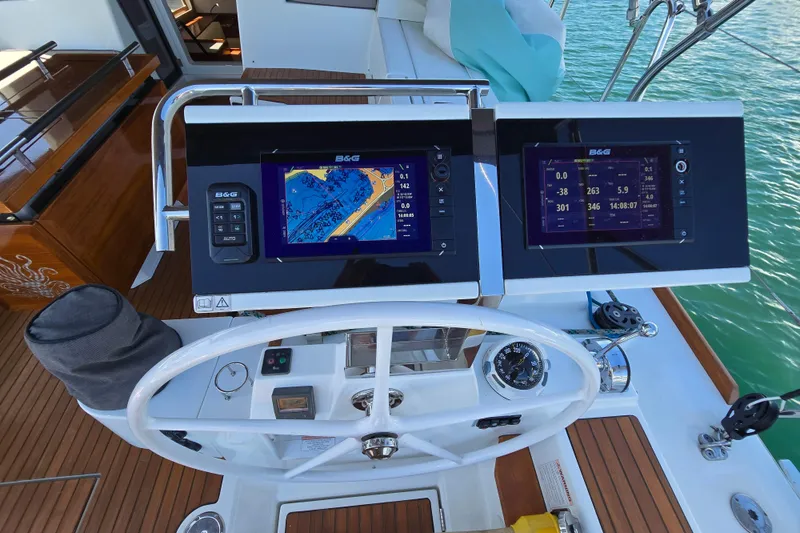 Slide: The Image of Steering console of 2016 Beneteau Oceanis 55 with navigation displays and controls. - 4
