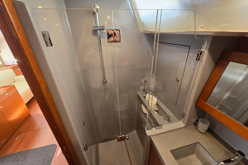 Slide: The Image of Luxurious bathroom in a 2016 Beneteau Oceanis 55 yacht with modern shower and sink. - 40