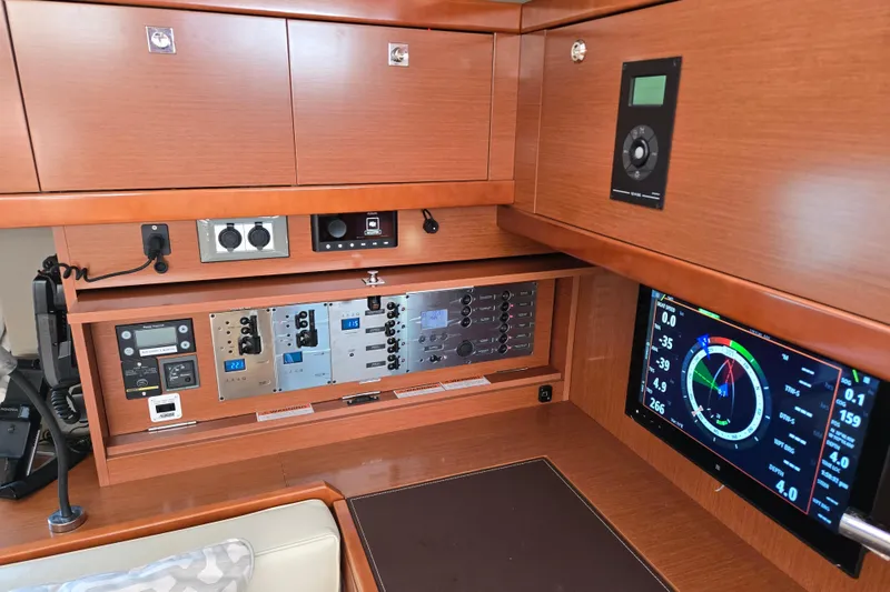 Slide: The Image of Control panel of a 2016 Beneteau Oceanis 55 yacht with navigation instruments and displays. - 44