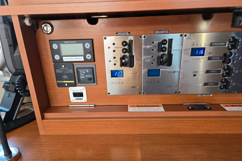 Slide: The Image of Control panel of a 2016 Beneteau Oceanis 55 yacht, featuring various switches and displays. - 47