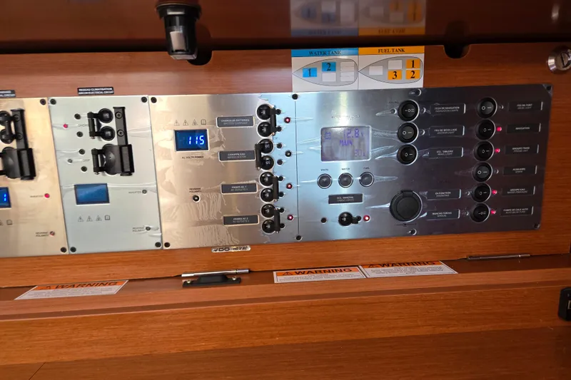 Slide: The Image of Control panel of a 2016 Beneteau Oceanis 55 yacht, featuring various switches and displays. - 49