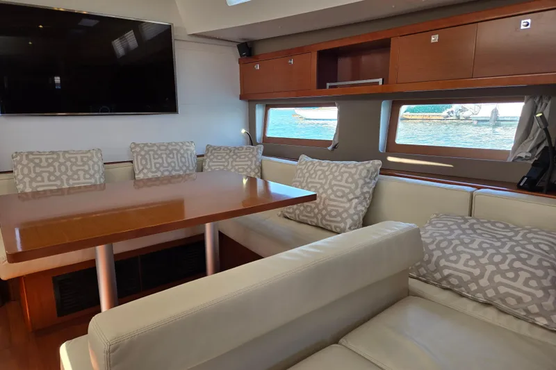 Slide: The Image of Luxurious interior of 2016 Beneteau Oceanis 55 yacht with elegant seating and large windows. - 51