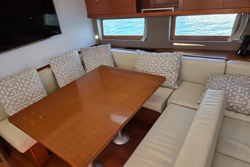 Slide: The Image of Interior of 2016 Beneteau Oceanis 55 yacht with elegant dining area and sea view. - 52