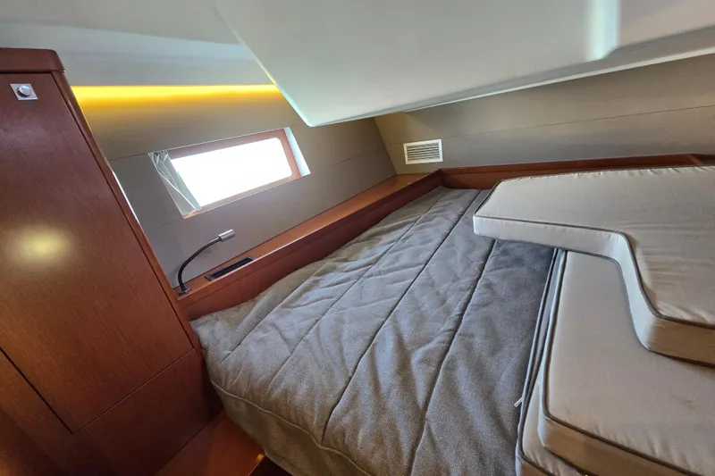 Slide: The Image of Luxurious cabin interior of a 2016 Beneteau Oceanis 55 yacht with cozy bedding. - 60