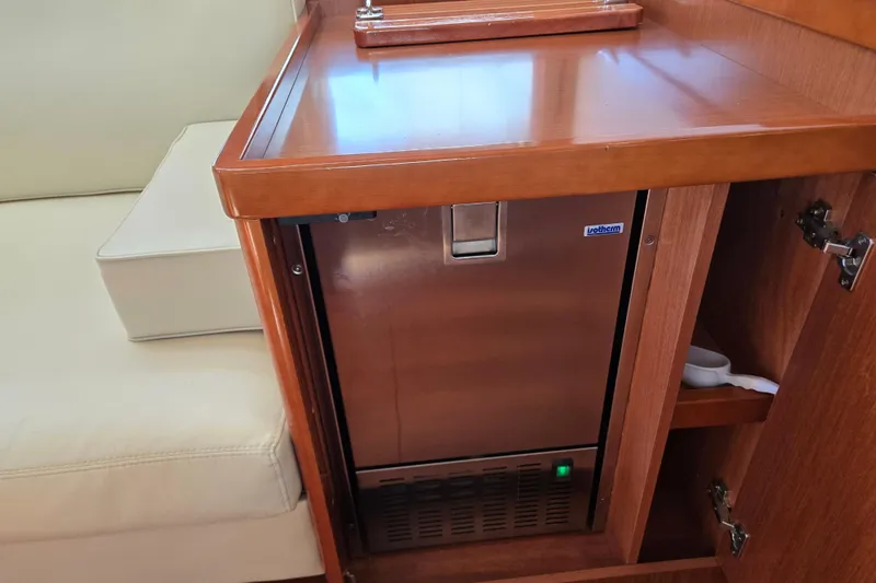 Slide: The Image of Wooden interior of 2016 Beneteau Oceanis 55 yacht with built-in refrigerator. - 61
