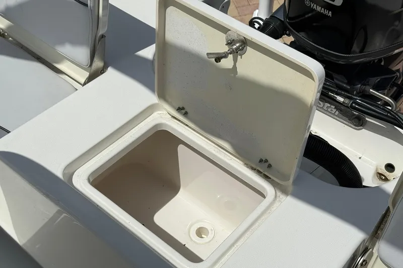 Slide: The Image of Open storage compartment on 2021 NauticStar 191 Hybrid boat, featuring Yamaha engine. - 12
