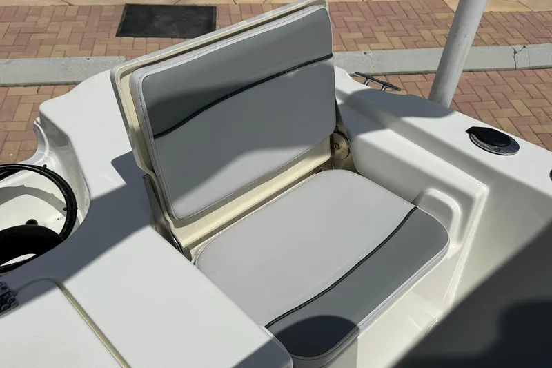 Slide: The Image of 2021 NauticStar 191 Hybrid boat seat with gray cushions and white trim. - 13