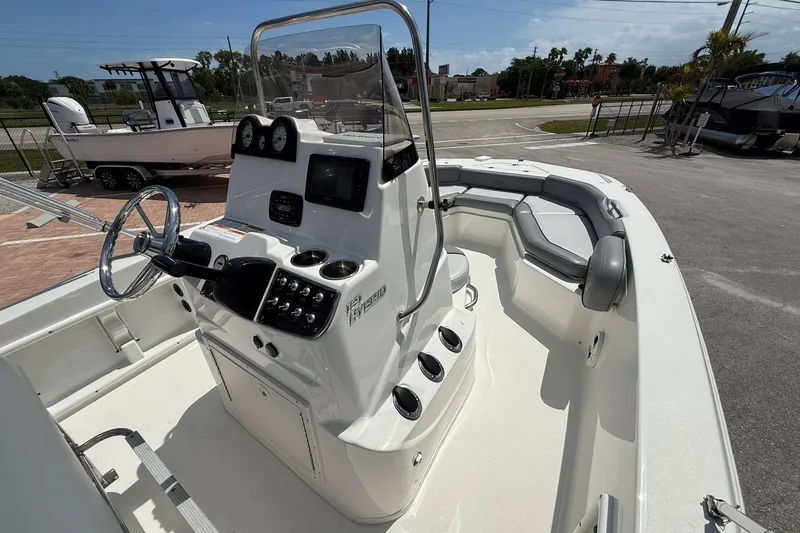 Slide: The Image of 2021 NauticStar 191 Hybrid boat interior with steering console and seating area. - 18