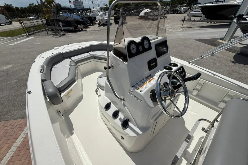 Slide: The Image of 2021 NauticStar 191 Hybrid boat interior with steering console and seating area. - 19