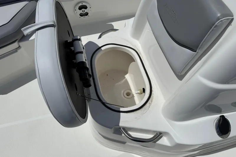 Slide: The Image of Open storage compartment on 2021 NauticStar 191 Hybrid boat with cushioned seating. - 24