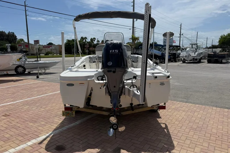 Slide: The Image of 2021 NauticStar 191 Hybrid boat with outboard motor in a parking lot. - 4