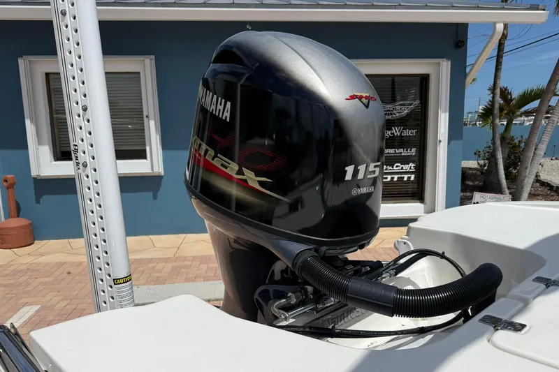 Slide: The Image of 2021 NauticStar 191 Hybrid with Yamaha 115 outboard motor in a sunny setting. - 9