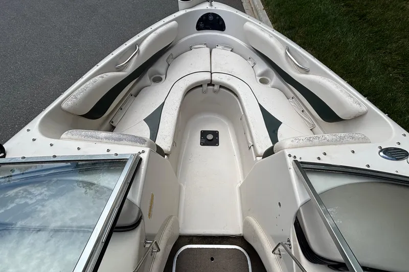 Slide: The Image of 2001 Larson 210 I/O boat interior with white seating and open windshield. - 5