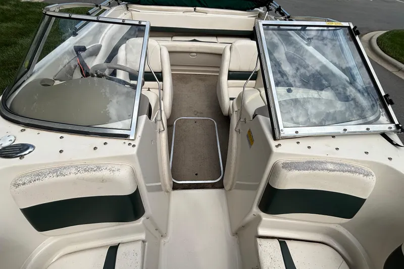 Slide: The Image of 2001 Larson 210 I/O boat interior with open windshield and seating. - 6