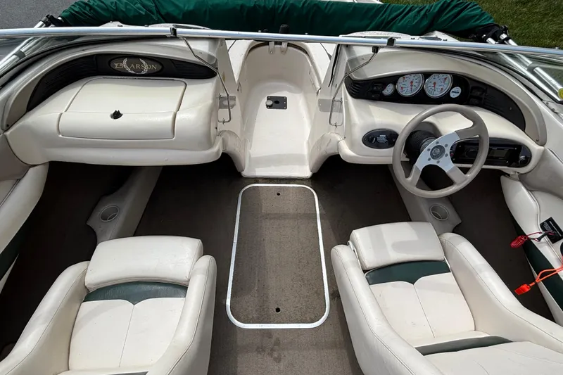 Slide: The Image of Interior of a 2001 Larson 210 I/O boat with white seating and dashboard. - 7