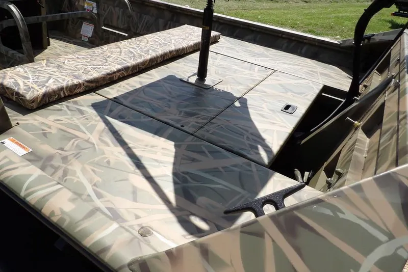 Slide: The Image of 2026 Crestliner 1760 Retriever FCC boat interior with camouflage design and seating. - 11