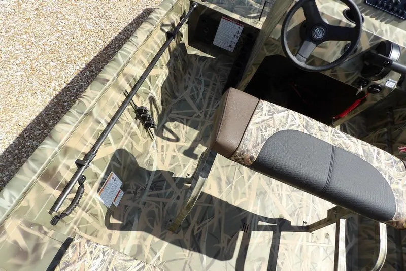 Slide: The Image of 2026 Crestliner 1760 Retriever FCC boat interior with camouflage design and steering wheel. - 12