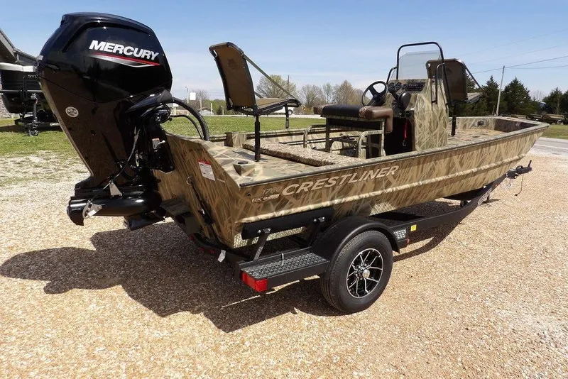 Slide: The Image of 2026 Crestliner 1760 Retriever FCC boat with Mercury engine on a trailer, camo design. - 16