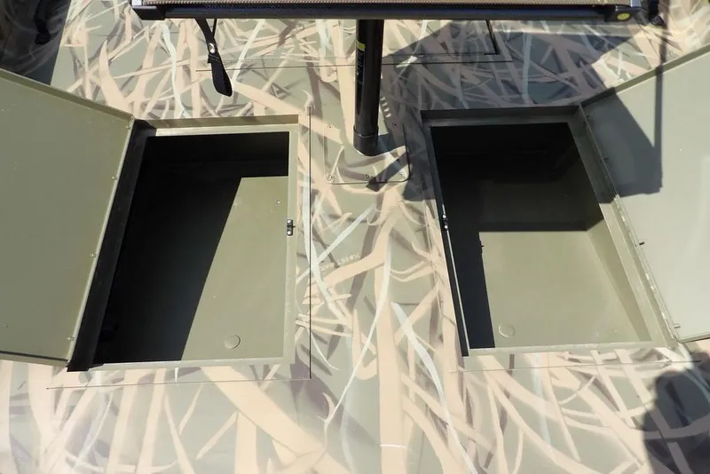 Slide: The Image of Open storage compartments on 2026 Crestliner 1760 Retriever FCC boat deck. - 19