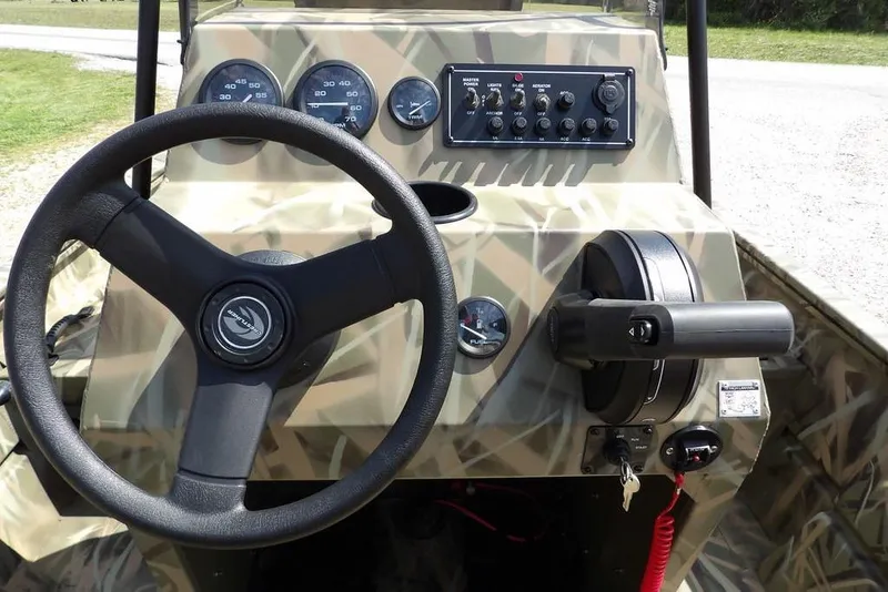 Slide: The Image of Steering console of 2026 Crestliner 1760 Retriever FCC boat with camouflage design. - 21