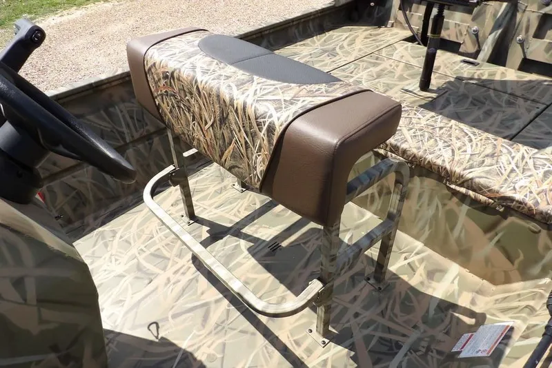 Slide: The Image of 2026 Crestliner 1760 Retriever FCC boat interior with camo seating and steering wheel. - 22