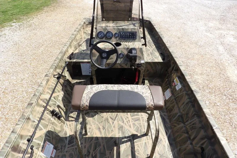 Slide: The Image of 2026 Crestliner 1760 Retriever FCC boat interior with camouflage design and steering console. - 25