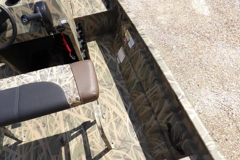 Slide: The Image of 2026 Crestliner 1760 Retriever FCC boat interior with camouflage design and seating. - 26