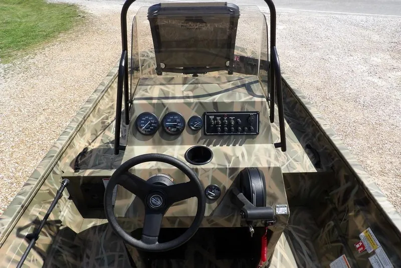 Slide: The Image of 2026 Crestliner 1760 Retriever FCC boat interior with camouflage design and control panel. - 27