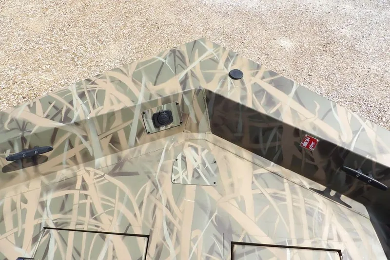 Slide: The Image of 2026 Crestliner 1760 Retriever FCC boat with camouflage design on deck. - 32