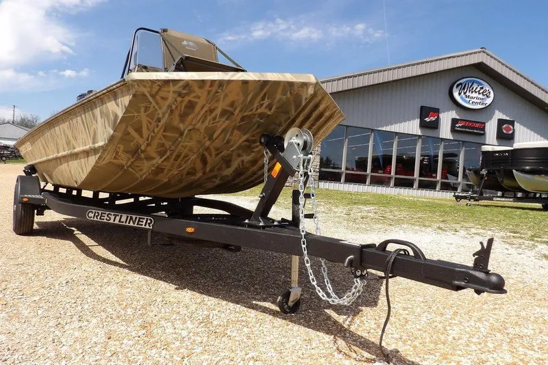 Slide: The Image of 2026 Crestliner 1760 Retriever FCC boat on trailer outside marine center. - 35